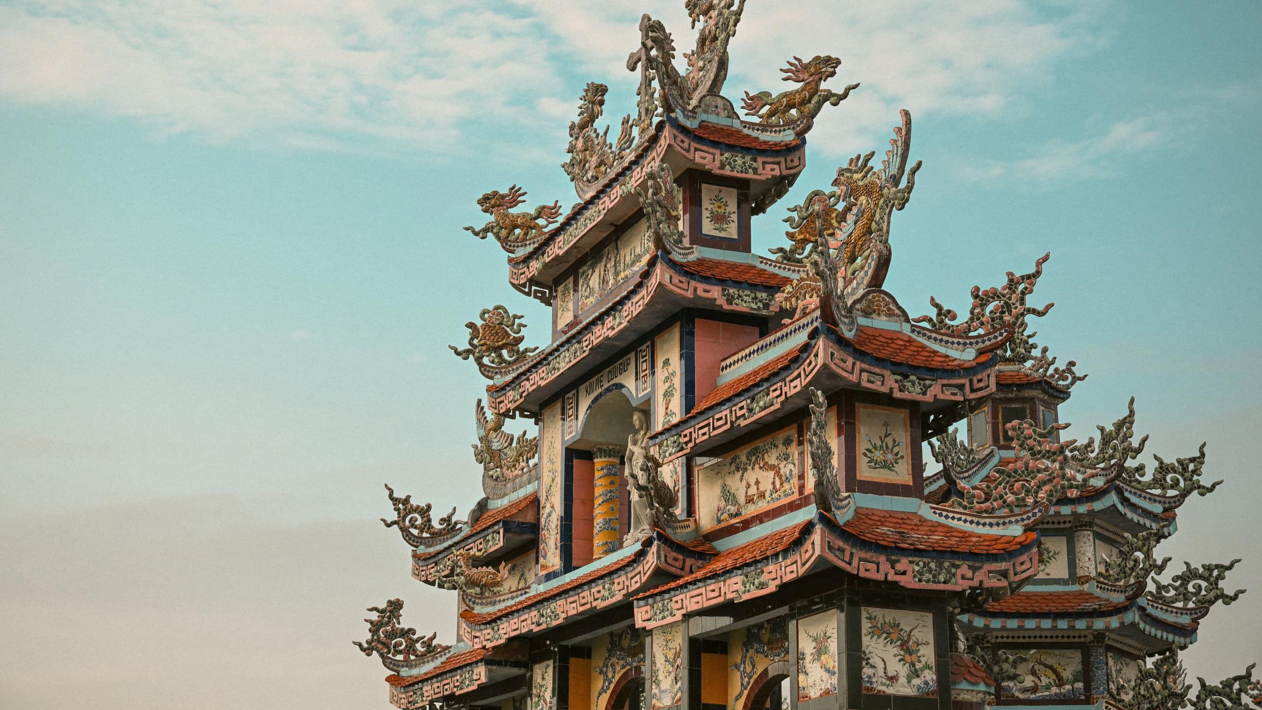 Ornate pagoda at Minh Cung Temple in Vietnam, showcasing traditional architecture - Contiki HCMC, Hoi An & Hanoi Tour
