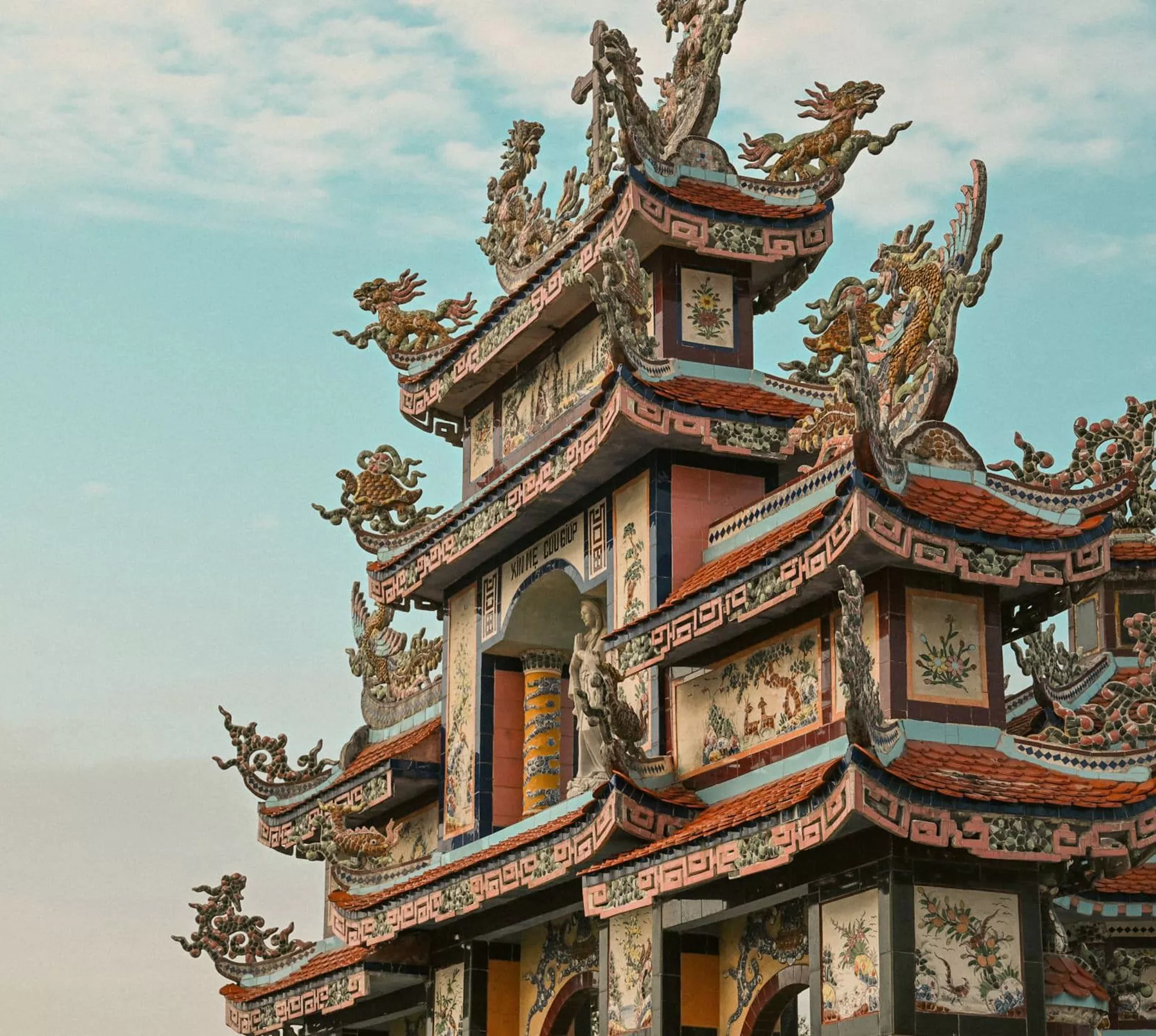 Ornate pagoda at Minh Cung Temple in Vietnam, showcasing traditional architecture - Contiki HCMC, Hoi An & Hanoi Tour