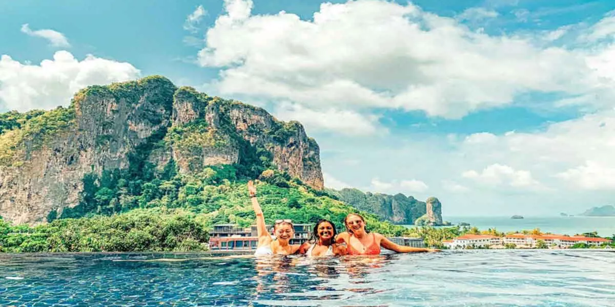 Group Enjoying A Pool With A View In Thailand