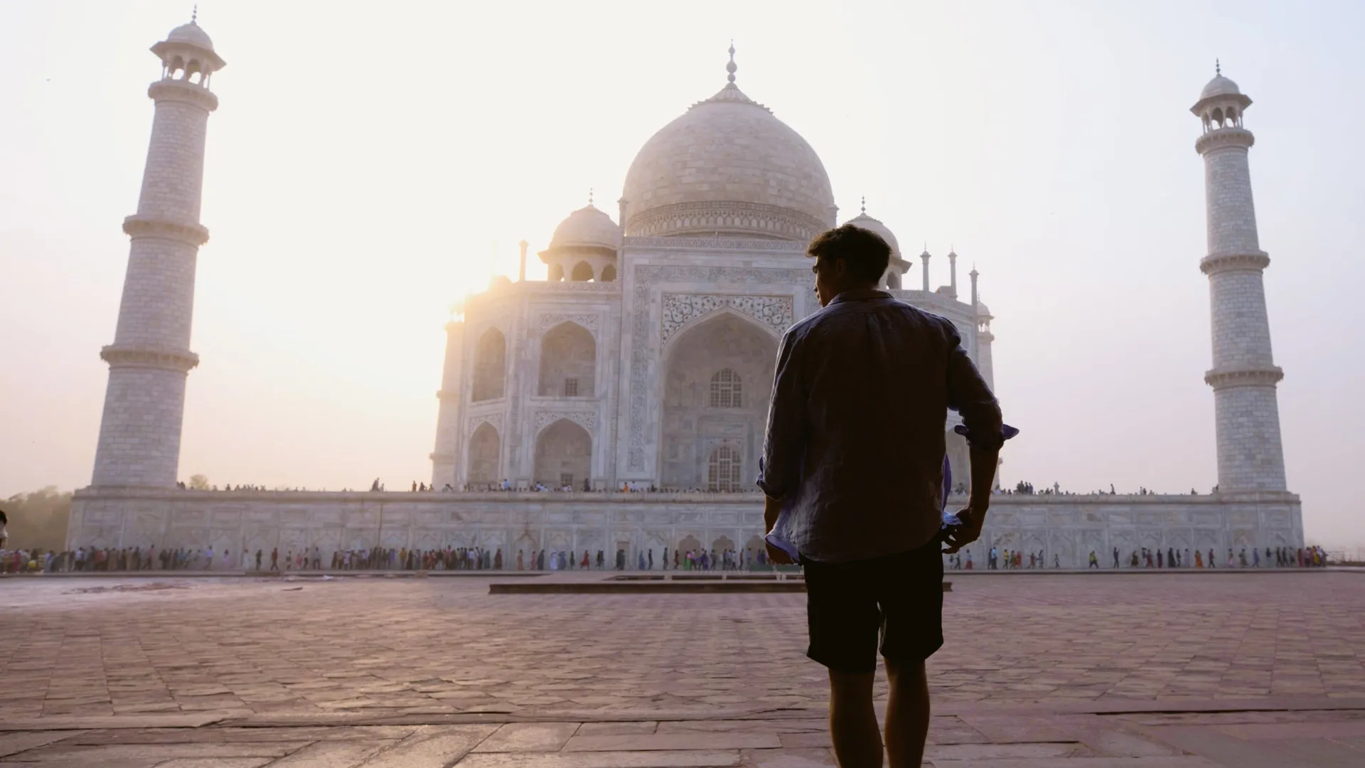 Sunrise illuminates the Taj Mahal as a Contiki traveller takes in India's most iconic monument on the Rajasthan & Golden Triangle Tour