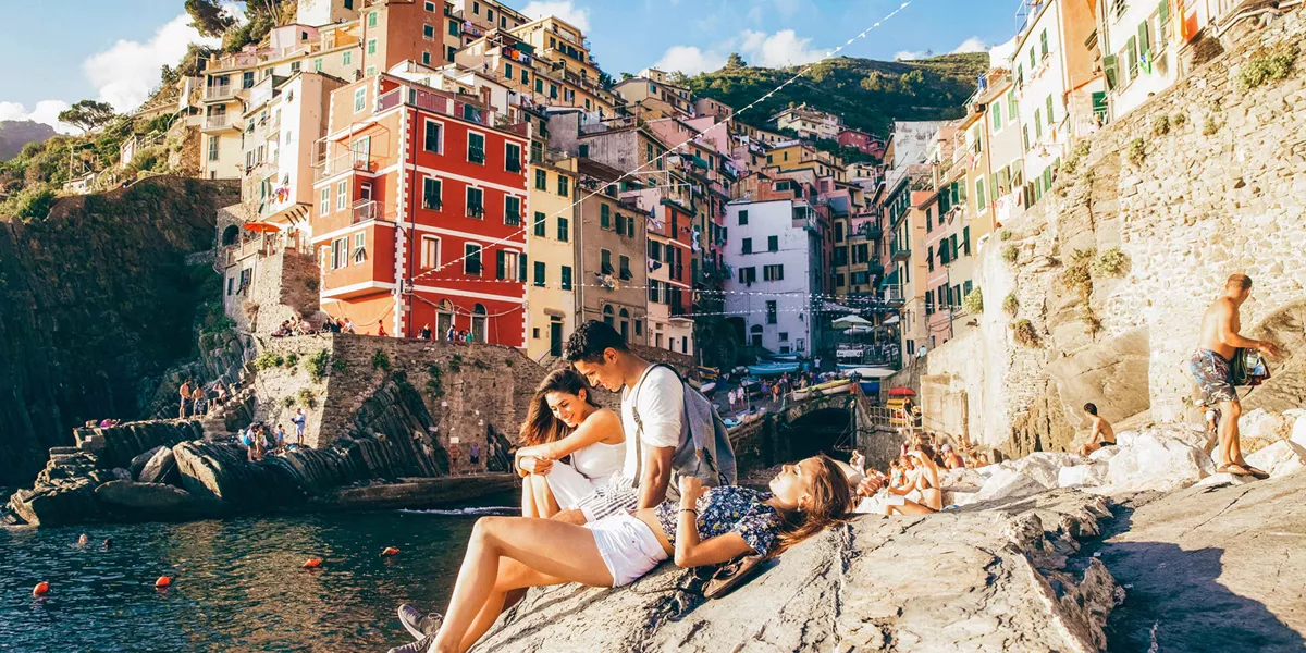 People Sat On Rocks In Italy