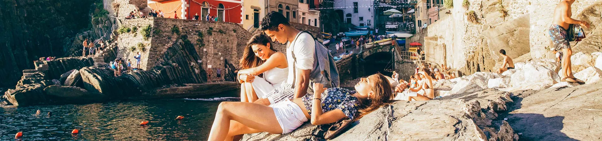 People Sat On Rocks In Italy