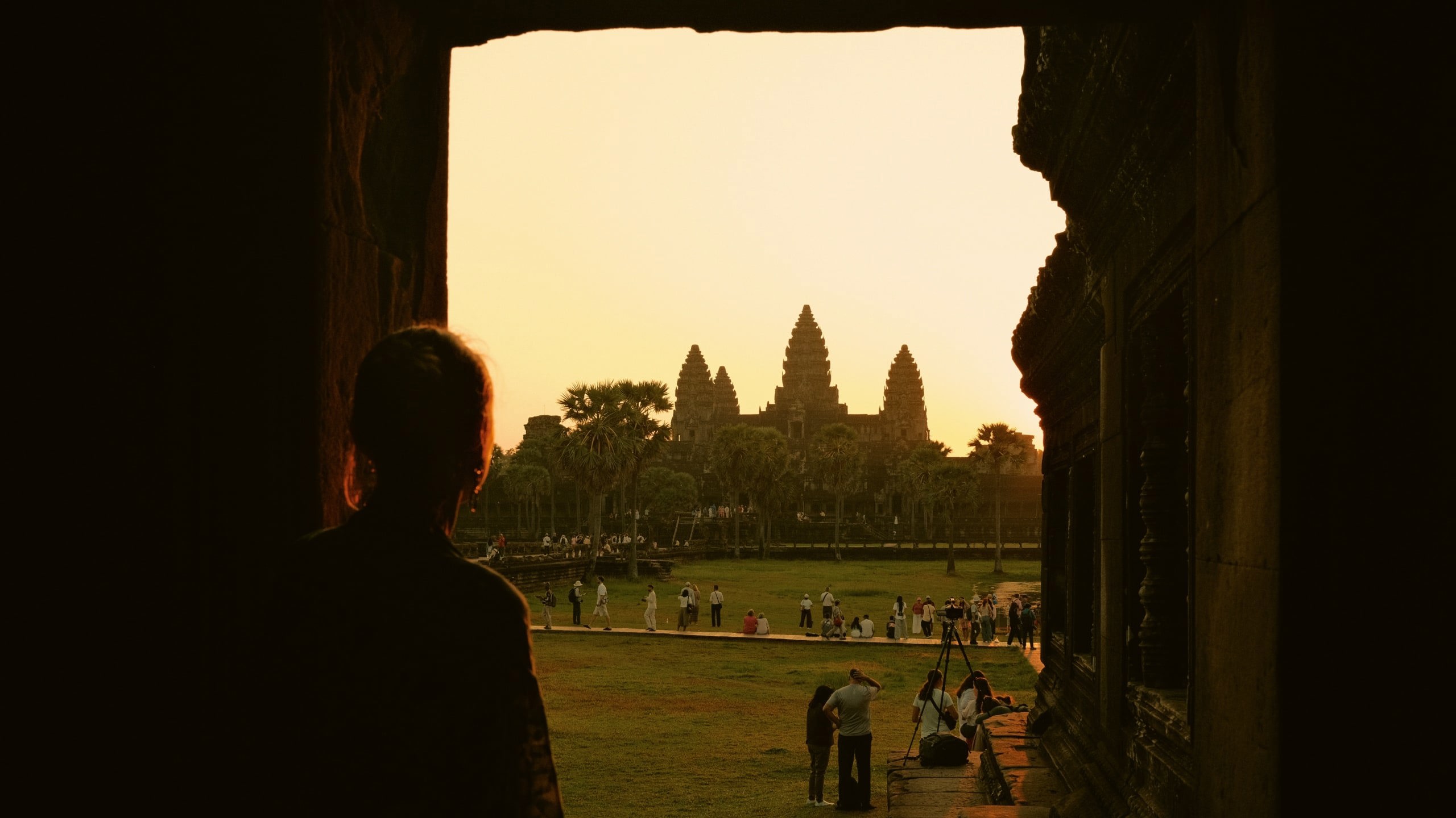 Traveller watches sunrise over Angkor Wat in Siem Reap, Cambodia, on the Contiki Cambodia & Laos Uncovered Tour, discovering one of Southeast Asia's most iconic ancient temples