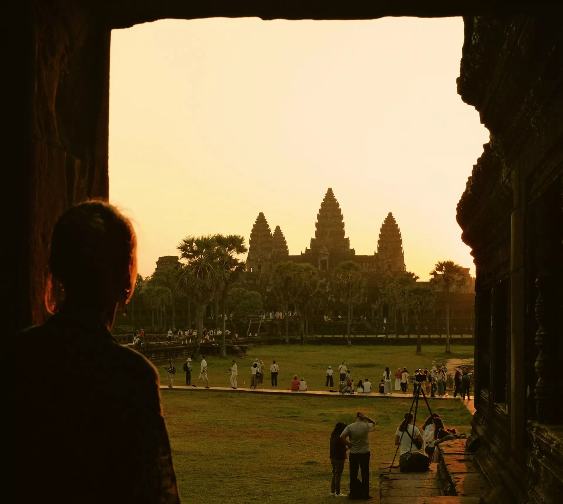 Traveller watches sunrise over Angkor Wat in Siem Reap, Cambodia, on the Contiki Cambodia & Laos Uncovered Tour, discovering one of Southeast Asia's most iconic ancient temples