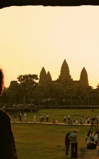 Traveller watches sunrise over Angkor Wat in Siem Reap, Cambodia, on the Contiki Cambodia & Laos Uncovered Tour, discovering one of Southeast Asia's most iconic ancient temples