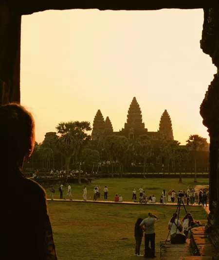 Traveller watches sunrise over Angkor Wat in Siem Reap, Cambodia, on the Contiki Cambodia & Laos Uncovered Tour, discovering one of Southeast Asia's most iconic ancient temples