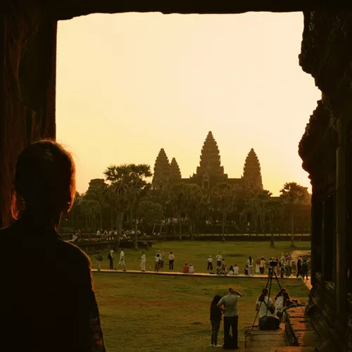 Traveller watches sunrise over Angkor Wat in Siem Reap, Cambodia, on the Contiki Cambodia & Laos Uncovered Tour, discovering one of Southeast Asia's most iconic ancient temples