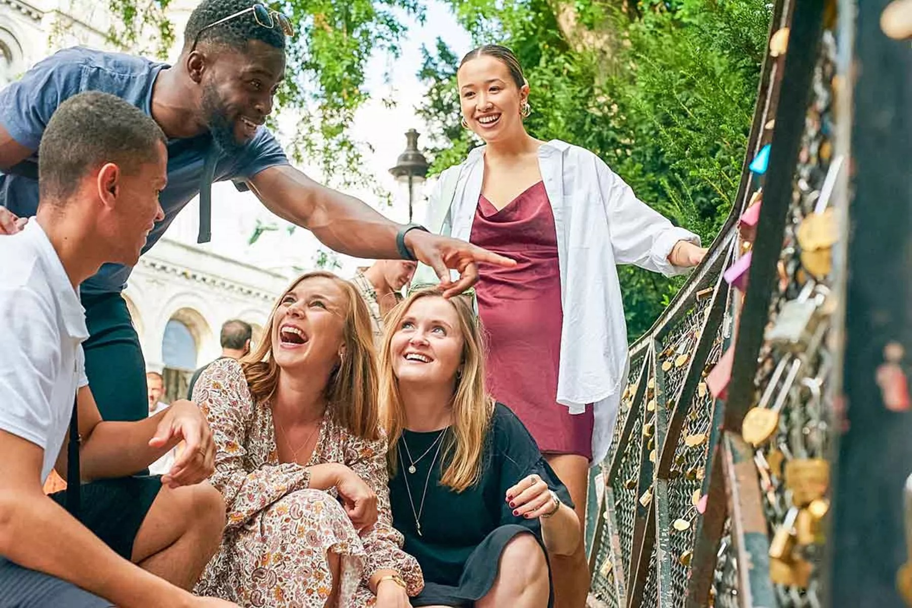 Group Of Young Travelers On Bridge In Paris France