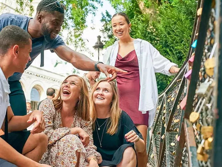 Group Of Young Travelers On Bridge In Paris France