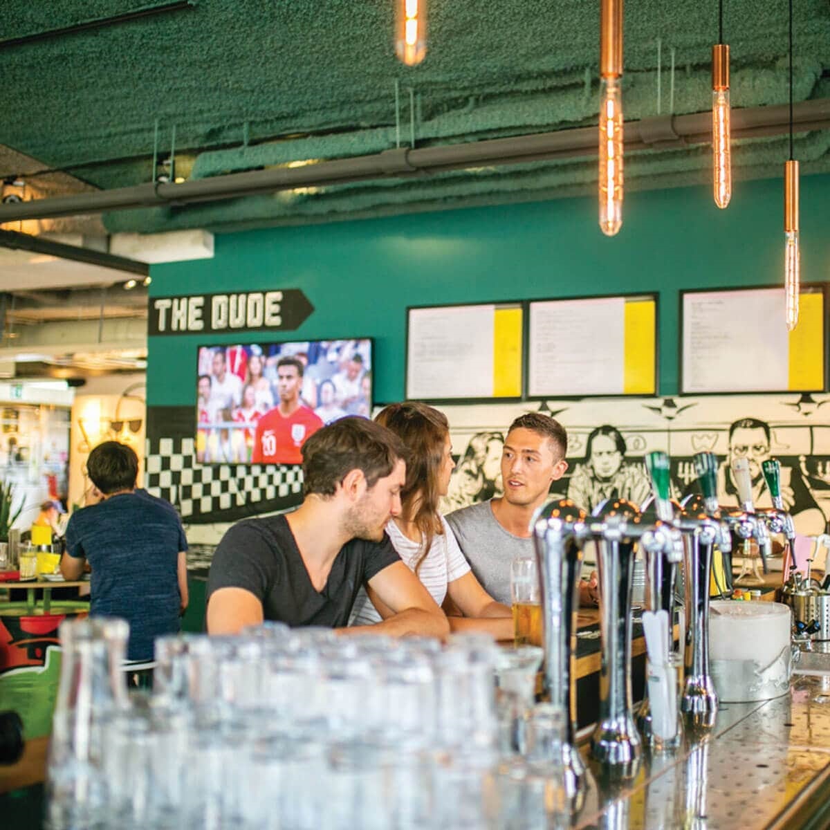 Young people sitting in pub and talking
