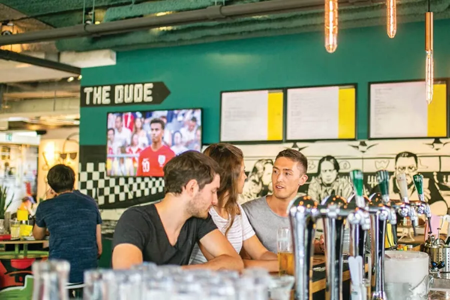 Young people sitting in pub and talking