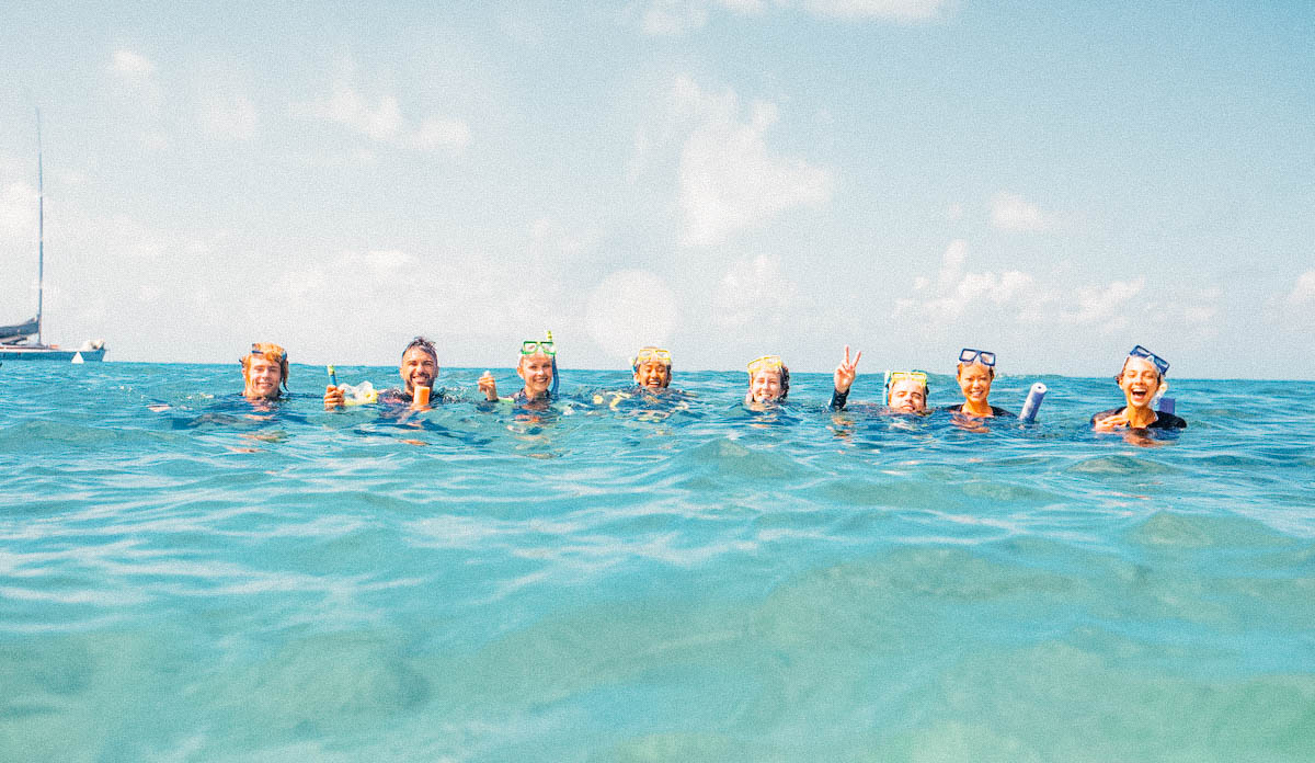 A group of people immersed up to their necks in the water