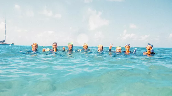 A group of people immersed up to their necks in the water