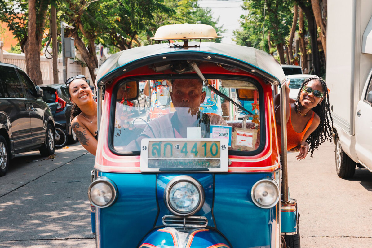 Two Friends Enjoying A Drive Ride In A Tuktuk