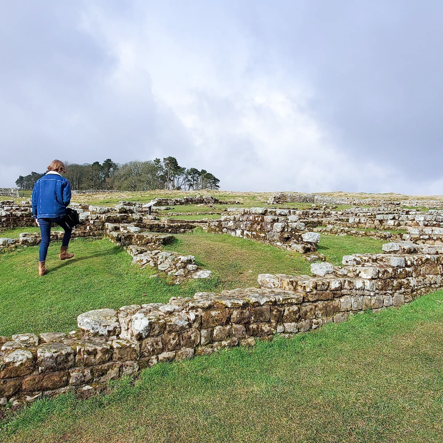Traveller walking on old fort at Hadrian's Wall, UK
