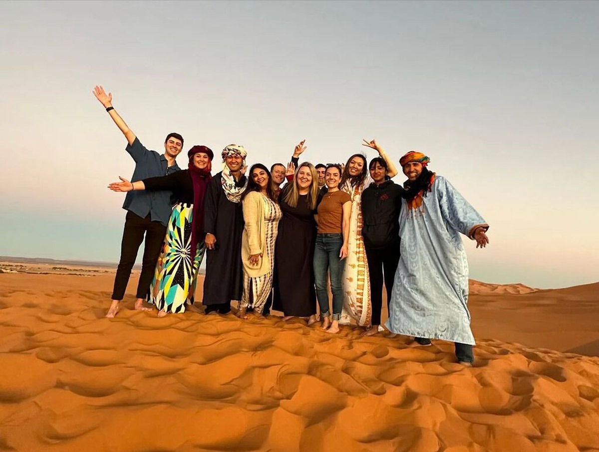 People Smiling Sand Ligh Blue Sky in Morocco