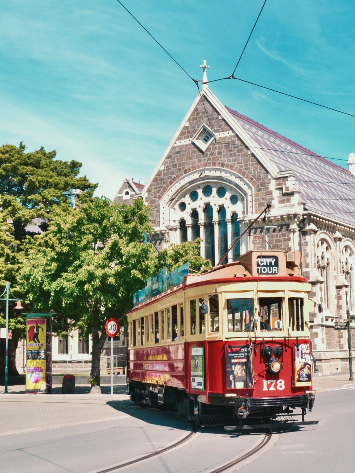 Historic Christchurch Tram passing Christchurch Cathedral in Christchurch, New Zealand.
