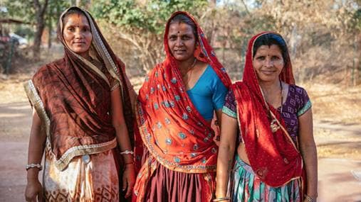 Three Indian women posing for a photo