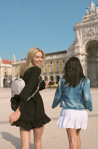 Two girls exploring Lisbon's Praça do Comércio - Contiki Spain & Portugal Uncovered Tour