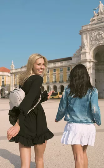 Two girls exploring Lisbon's Praça do Comércio - Contiki Spain & Portugal Uncovered Tour
