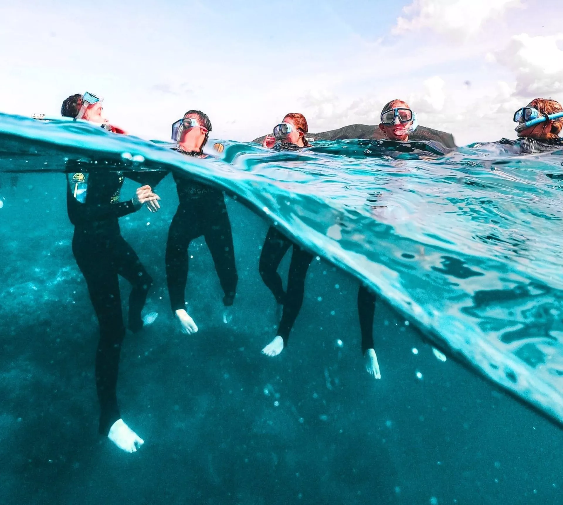 Travellers snorkelling on the Great Barrier Reef in Australia during the Contiki Snorkel & Dive Tour