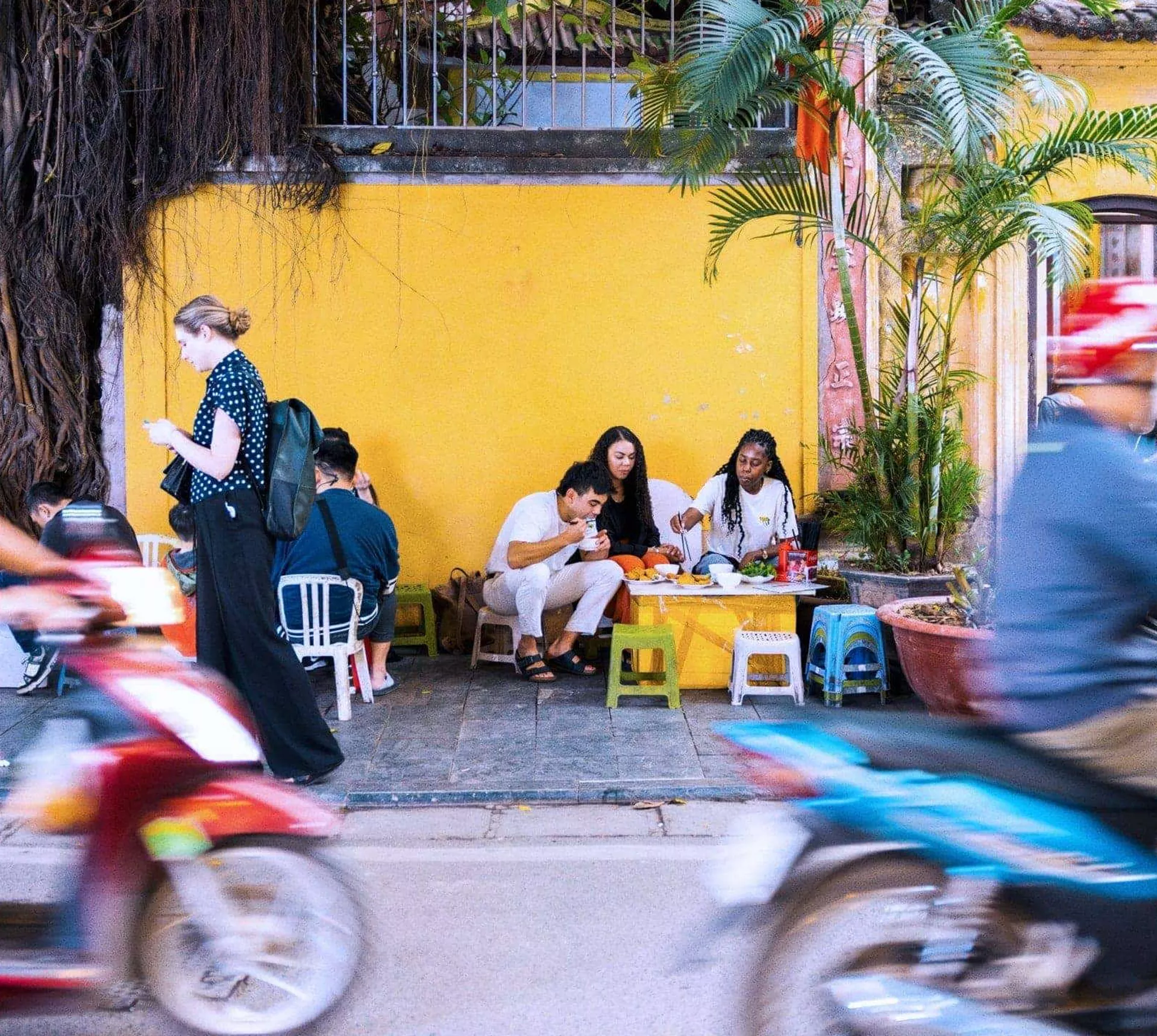 Contiki travellers sampling Vietnamese street food in Hoi An - Contiki Hanoi to Siem Reap Tour