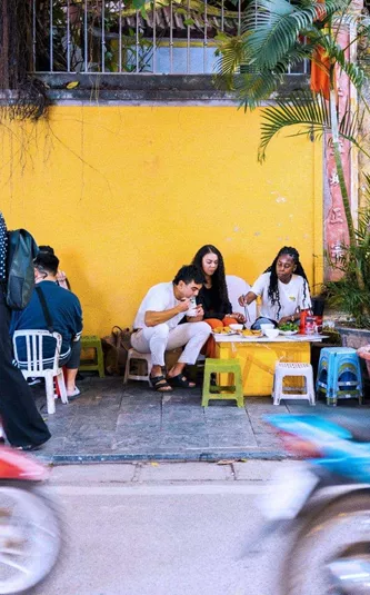 Contiki travellers sampling Vietnamese street food in Hoi An - Contiki Hanoi to Siem Reap Tour