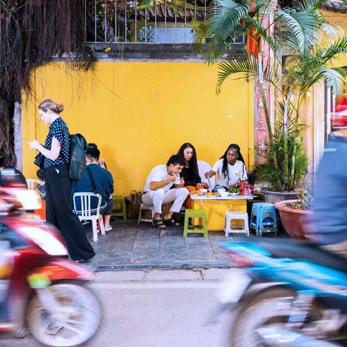 Contiki travellers sampling Vietnamese street food in Hoi An - Contiki Hanoi to Siem Reap Tour