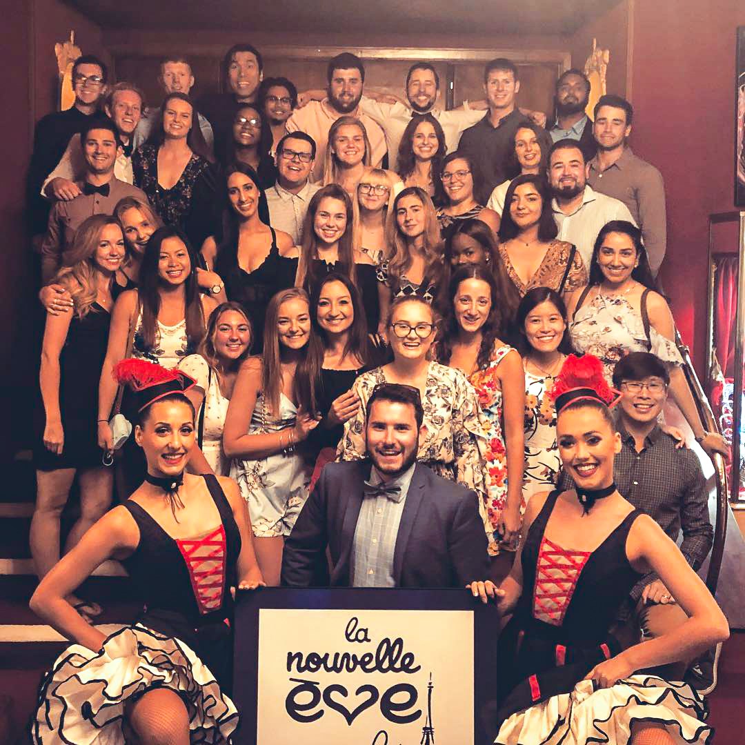A group picture with dancers at the Nouvelle Eve Cabaret show in Paris, France 