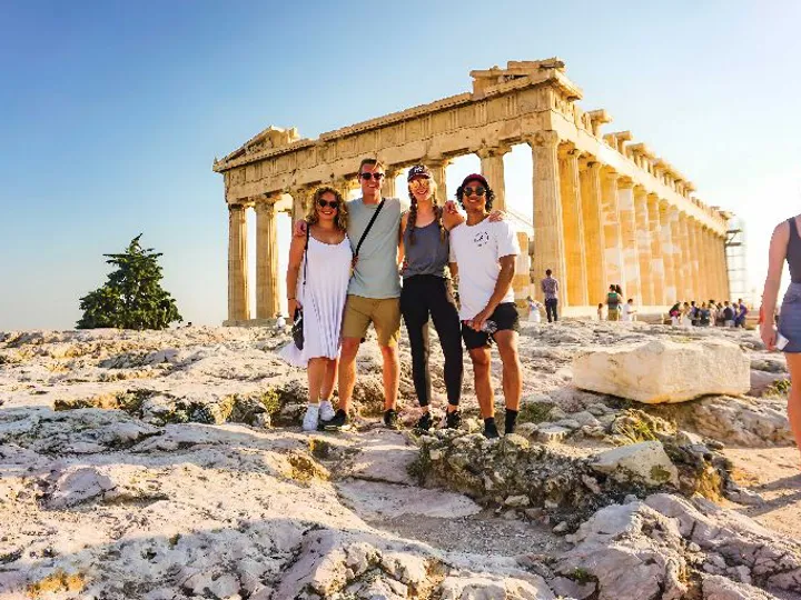 Four People Snating In Front Of Landmark Sunny Day