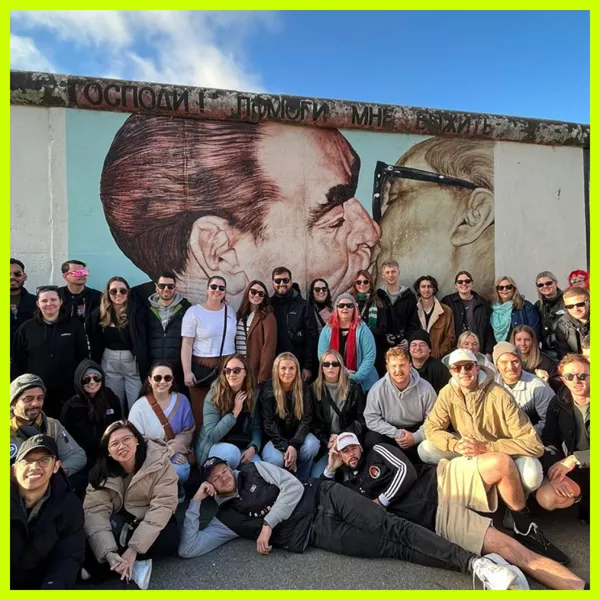 Group of travellers in front of the Berlin Wall, Germany