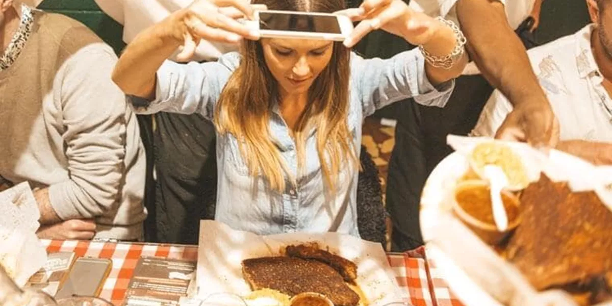  A Woman Taking a Picture of a Texan Steak