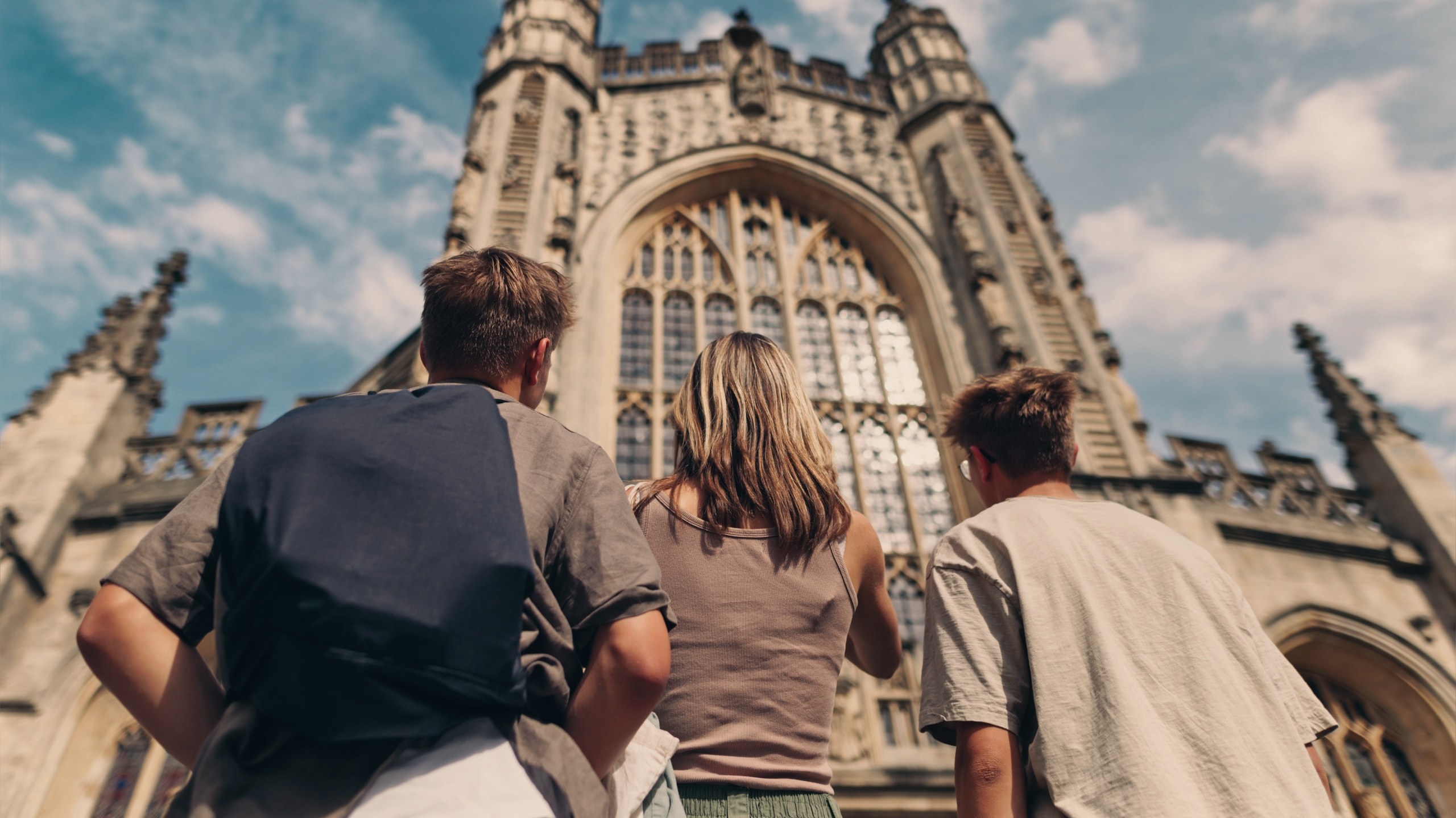 Travellers admire the historic Bath Abbey in Bath, England, during the Contiki England in a Week Tour