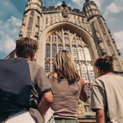 Travellers admire the historic Bath Abbey in Bath, England, during the Contiki England in a Week Tour
