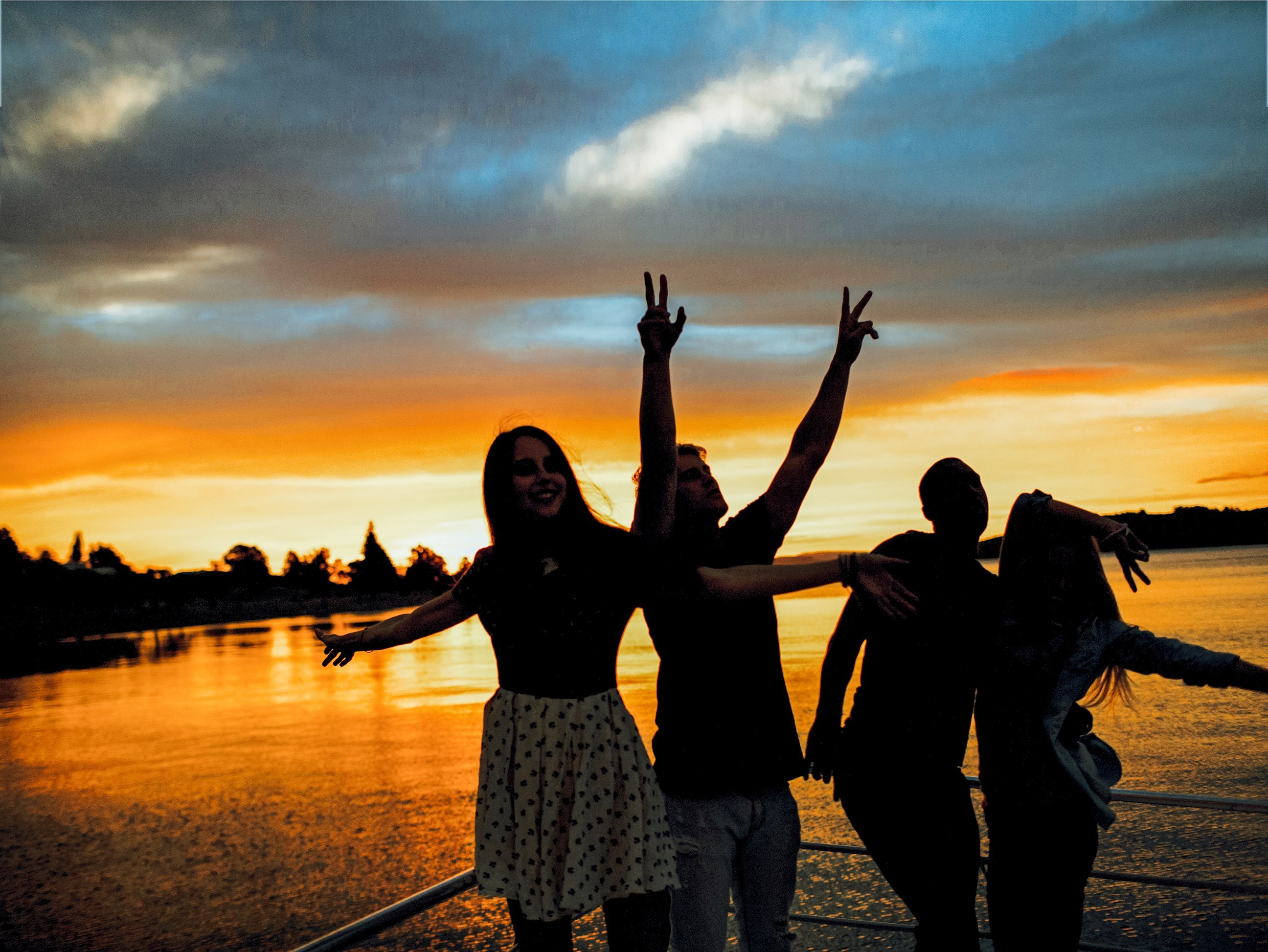 Travellers on a cruise during sunset in Lake Taupo, New Zealand