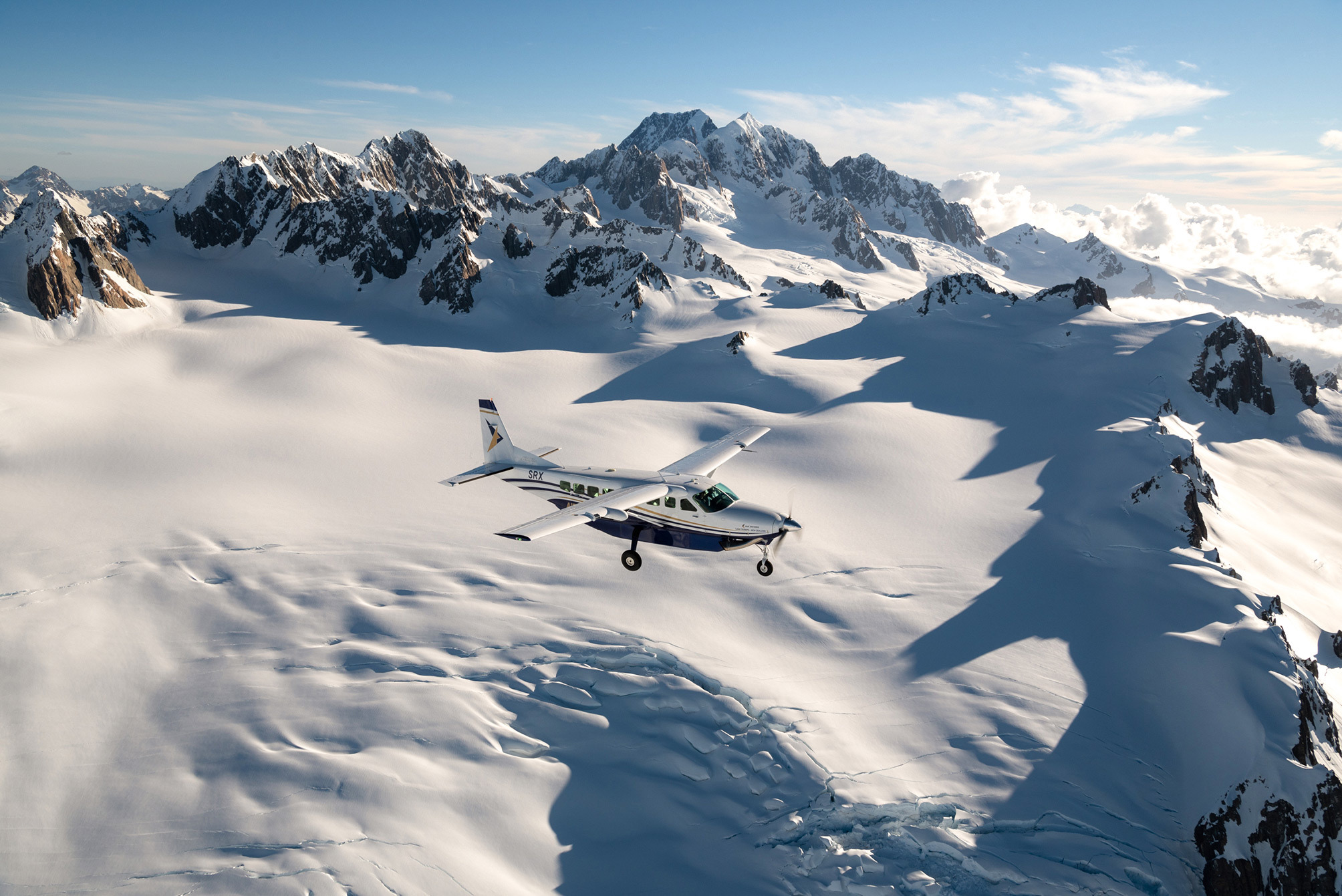 Plane flying over snowy mountains near Lake Tekapo, New Zealand