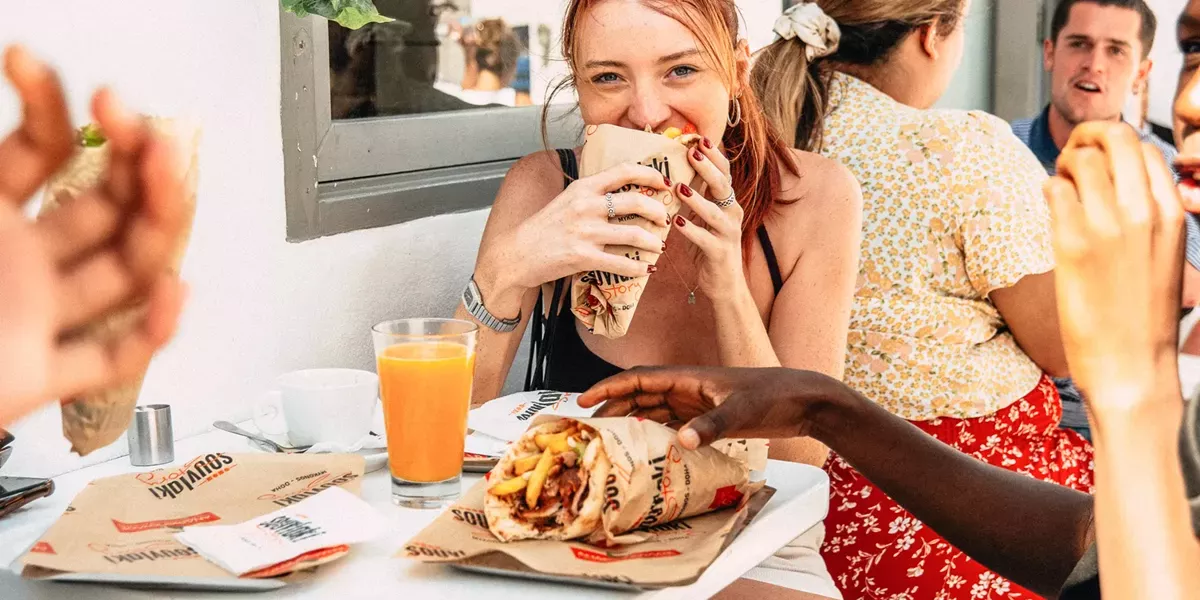 Young Woman Enjoyingl Greek Food