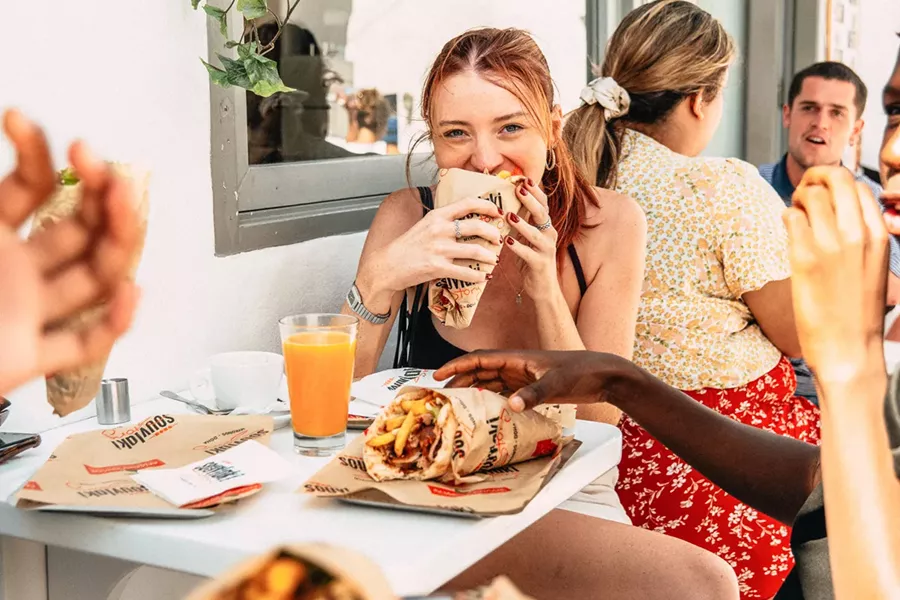 Young Woman Enjoyingl Greek Food