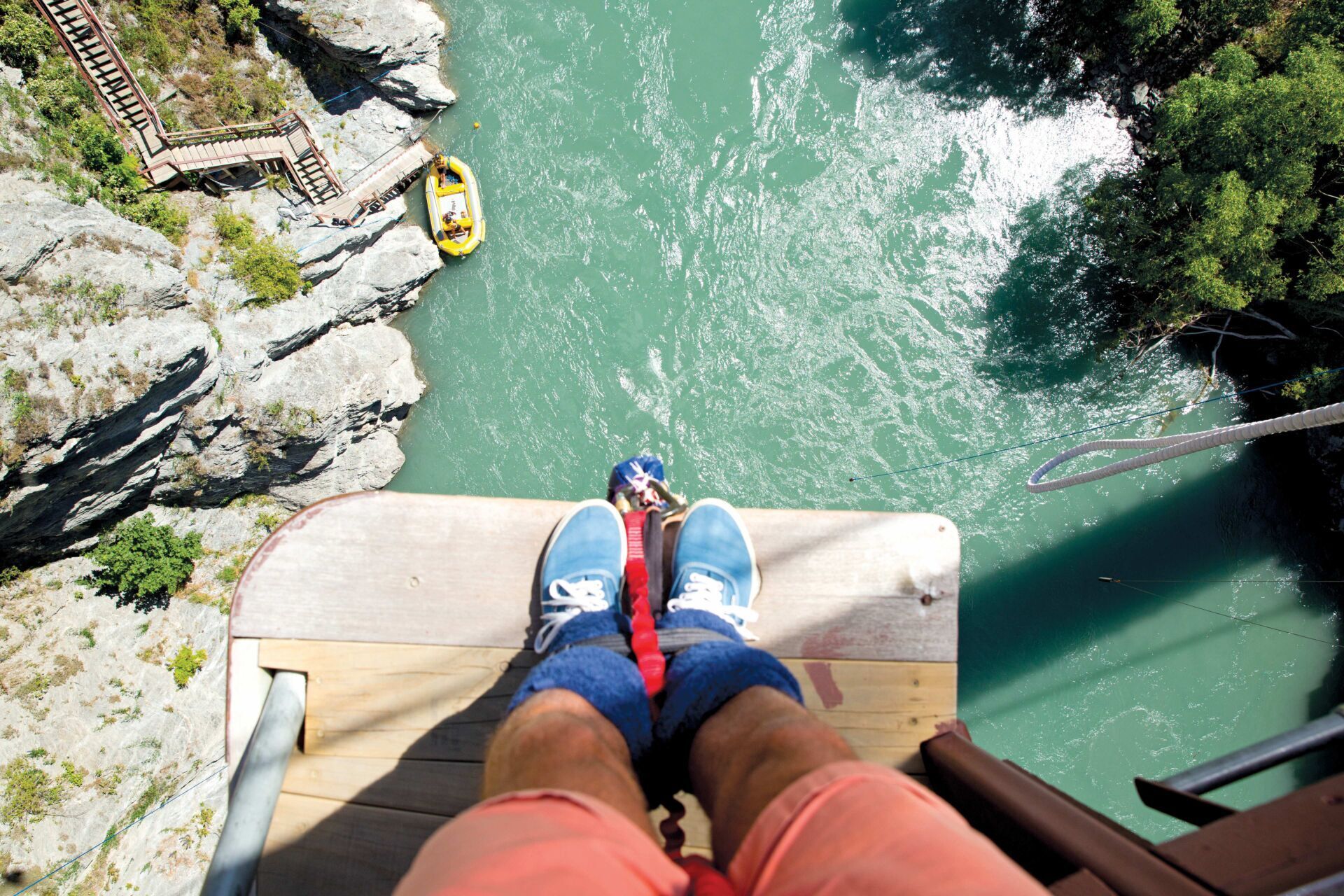 Bungee jumper looking down at the water
