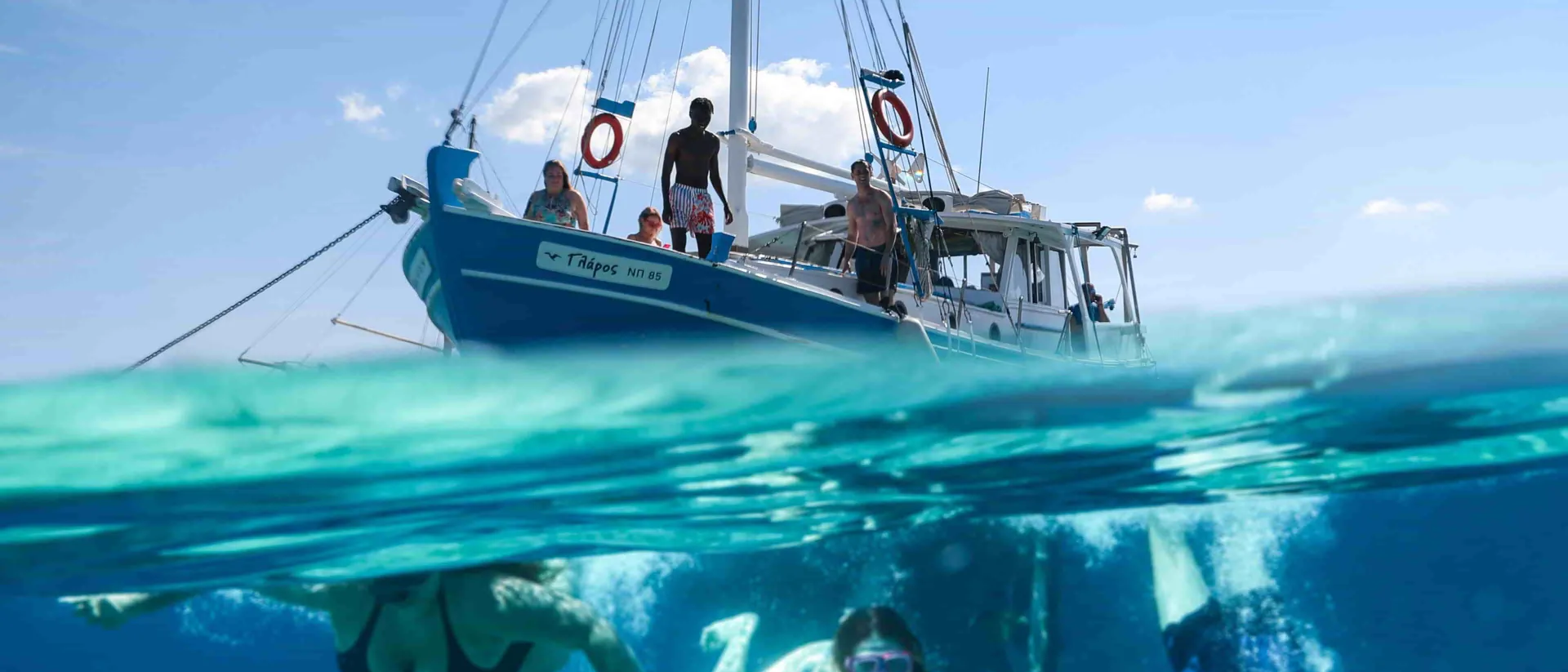 People Swimming In The Sea Boat Close To Them