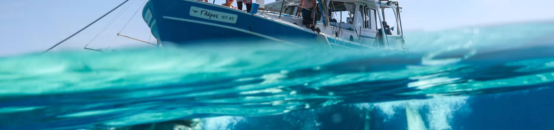 People Swimming In The Sea Boat Close To Them