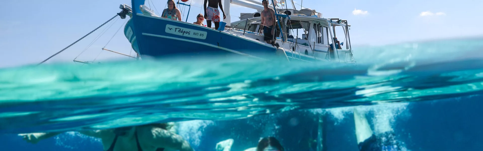 People Swimming In The Sea Boat Close To Them