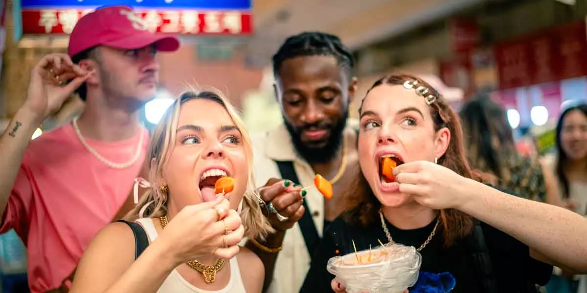 Grou Of Young Travelers Eating Street Food South Korea