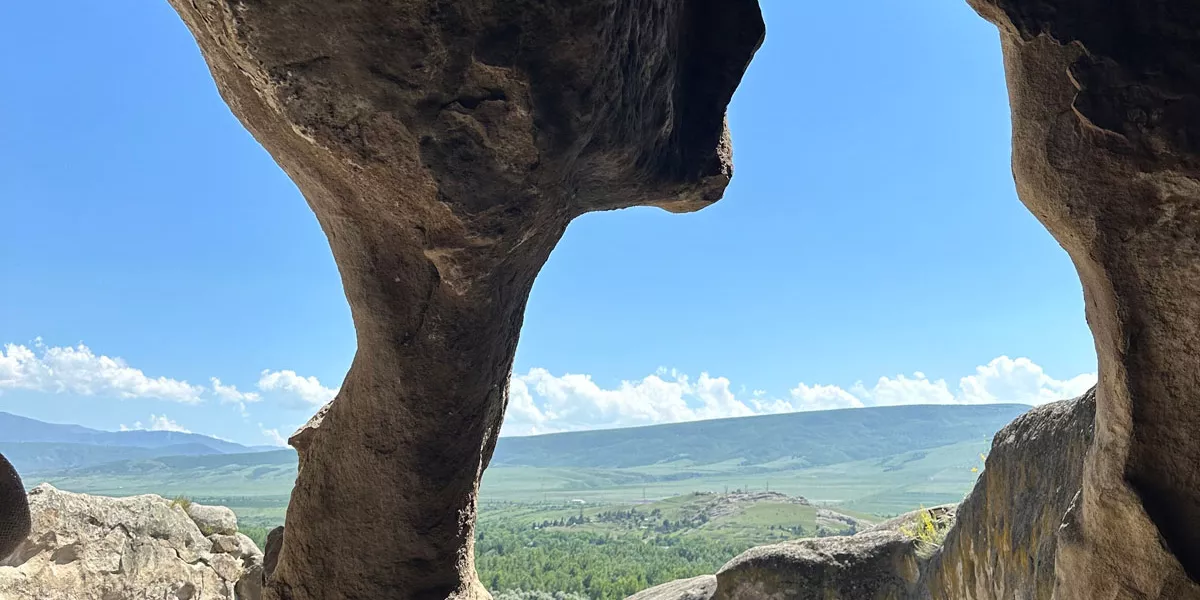 Rock Shaped Naturally Looking Like A Gate Sea As Background