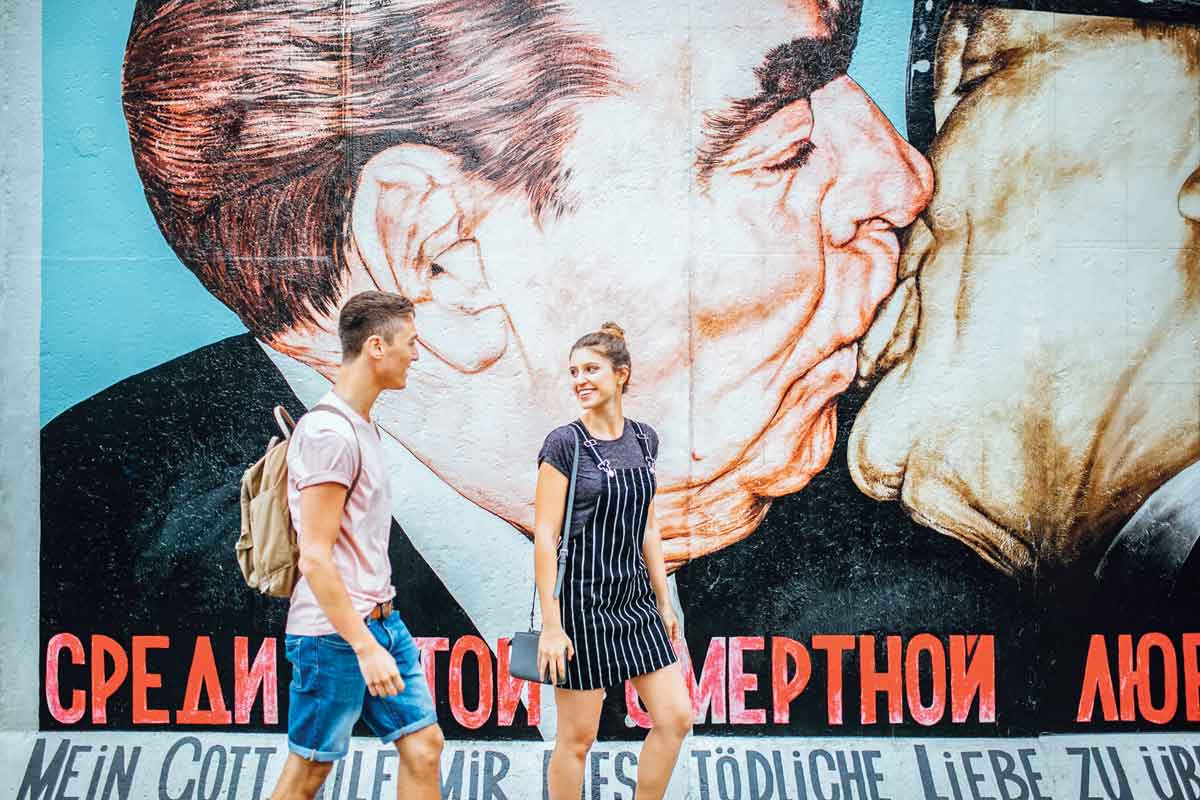 Travellers walking past the Berlin Wall in Germany