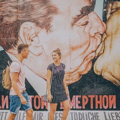 Travellers walking past mural
