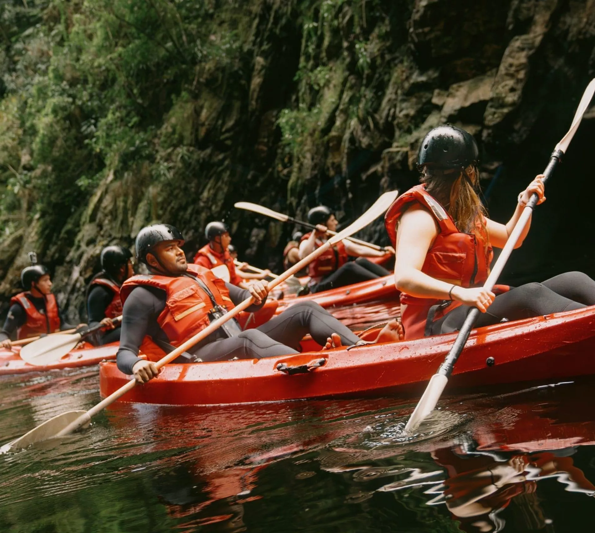 Travellers kayaking through the river on Contiki's Garden Route & Addo Tour in South Africa