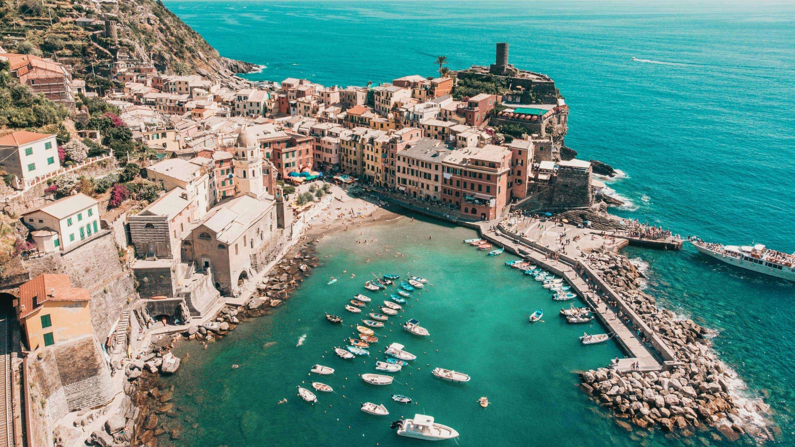 Aerial view of Vernazza's colourful harbour and Mediterranean coastline in Cinque Terre on the Contiki Best of Italy with Sicily Tour