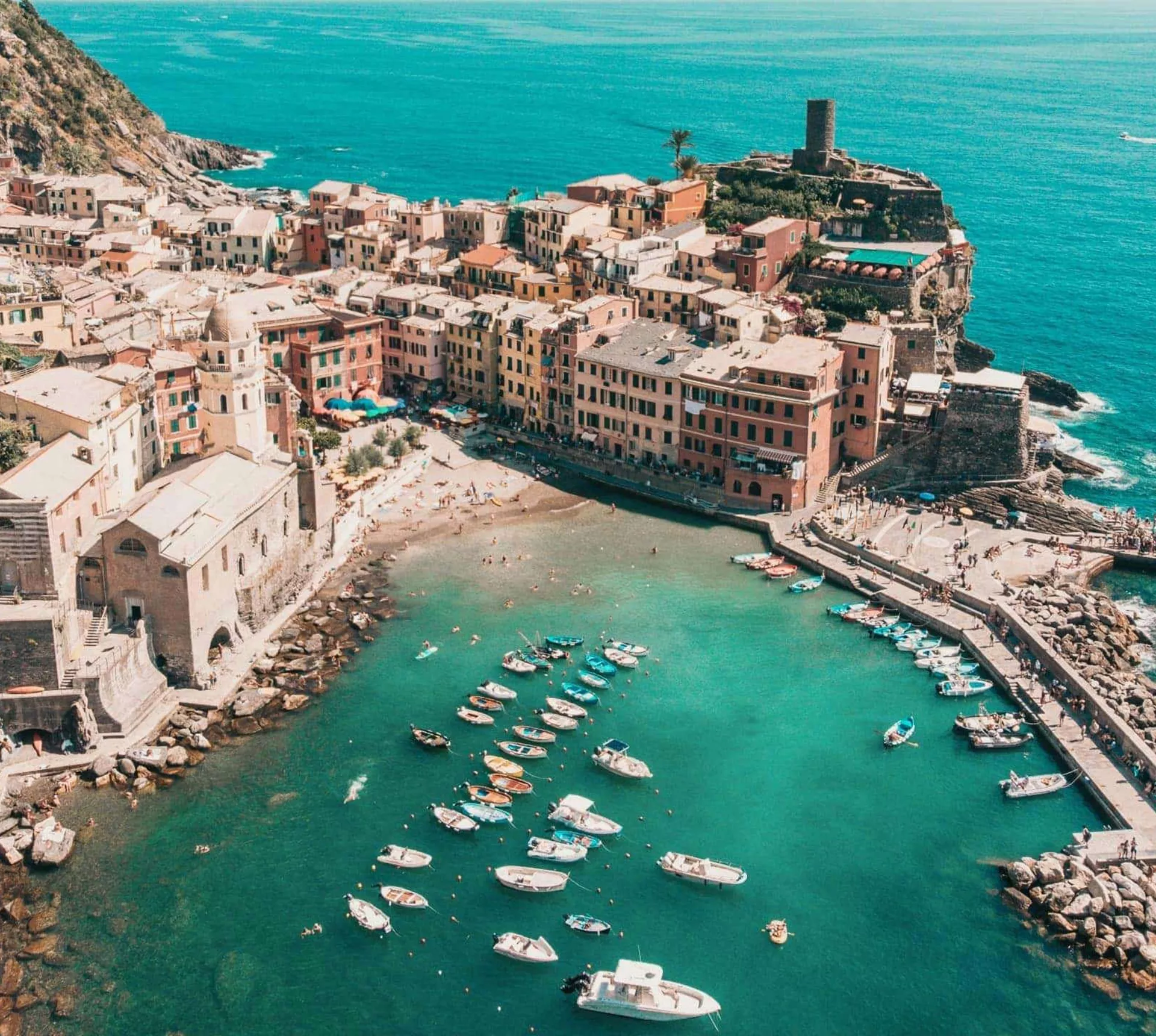 Aerial view of Vernazza's colourful harbour and Mediterranean coastline in Cinque Terre on the Contiki Best of Italy with Sicily Tour