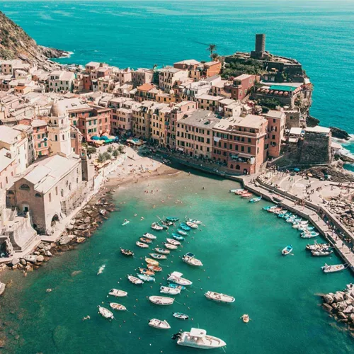 Aerial view of Vernazza's colourful harbour and Mediterranean coastline in Cinque Terre on the Contiki Best of Italy with Sicily Tour